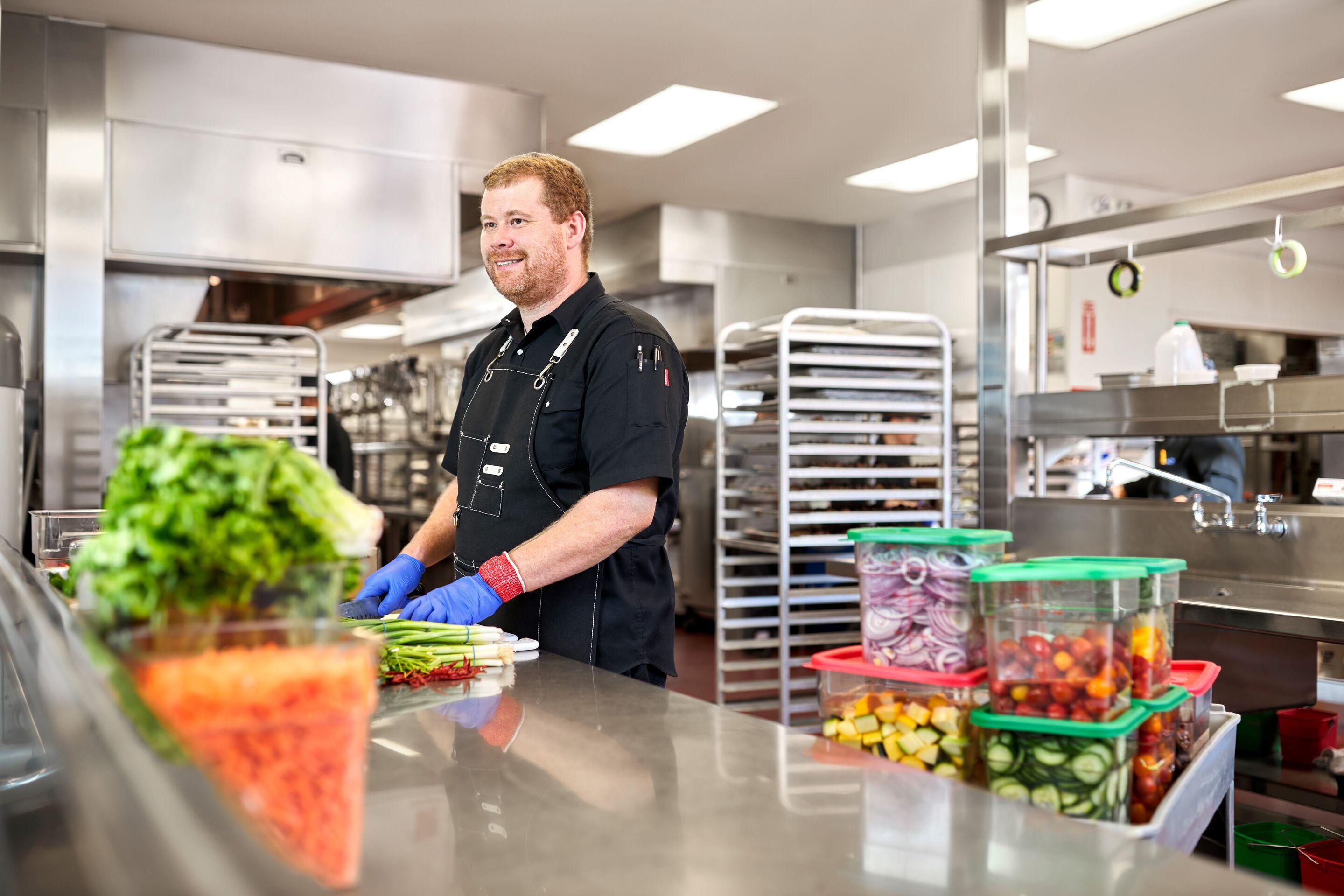 Chef prepping ingredients in catering kitchen