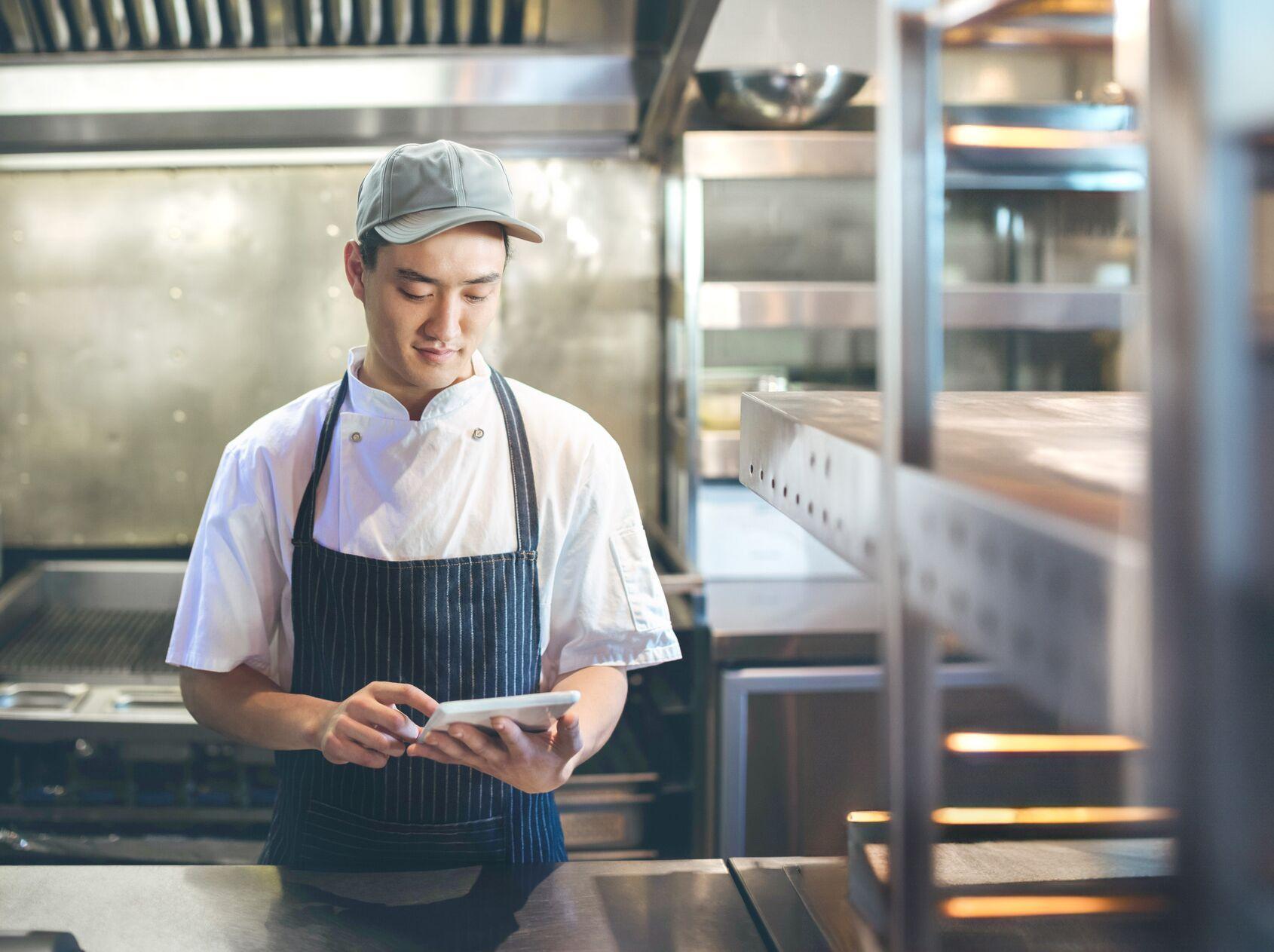 Chef using digital tablet in the commercial kitchen