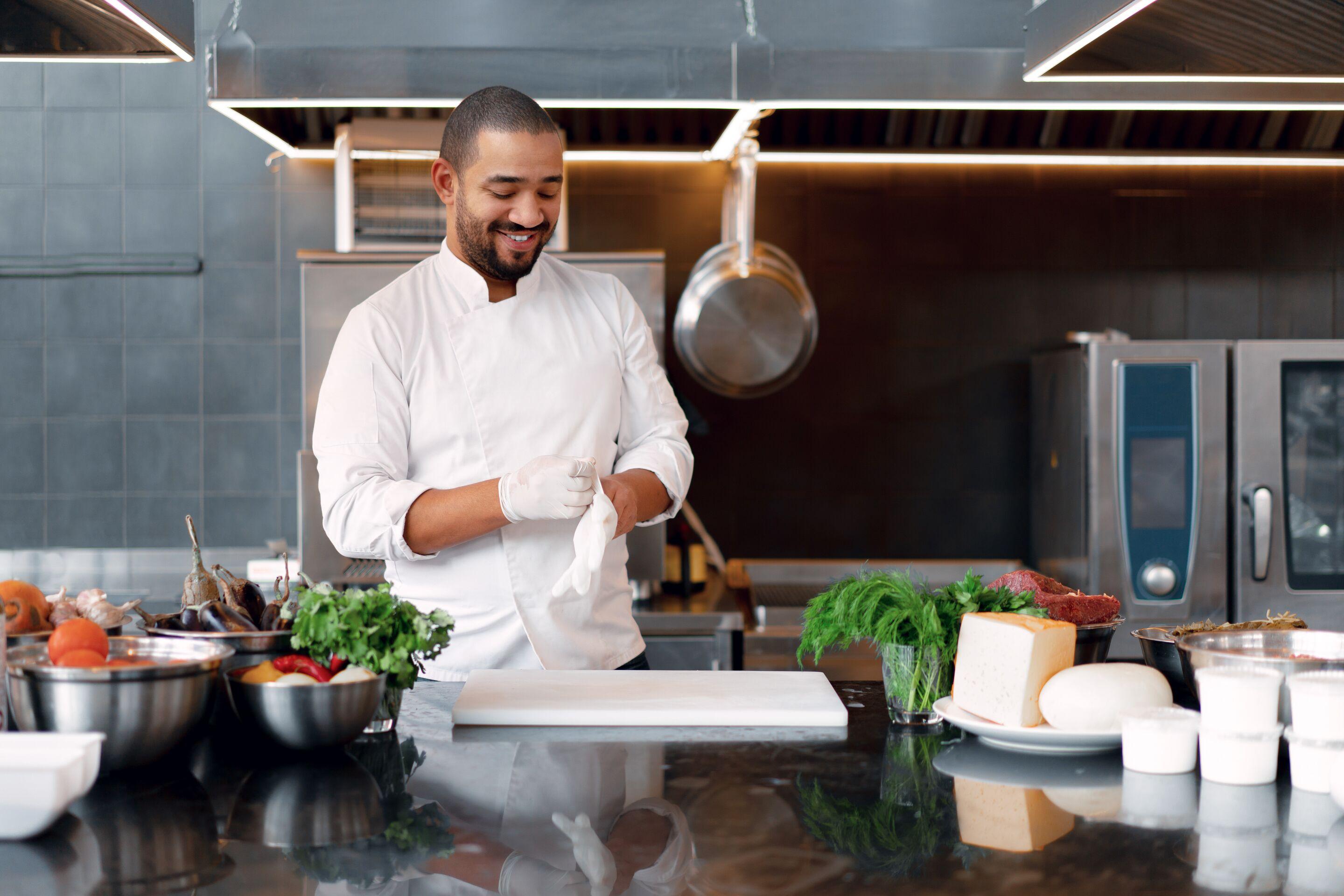 Chef putting on gloves to prep ingredients